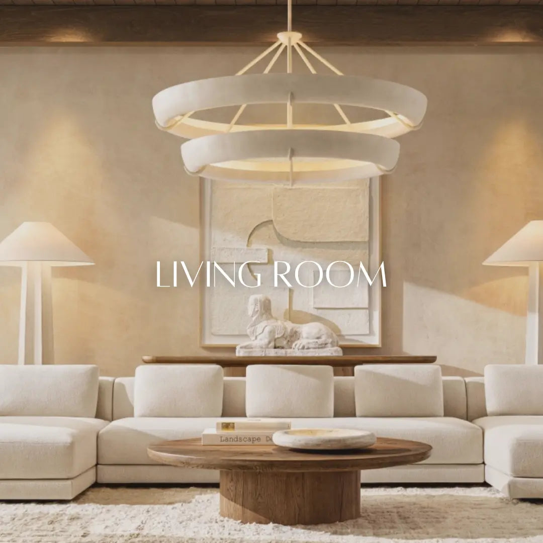 A modern living room with a large chandelier, abstract wall art, a white sectional sofa, wooden coffee table, and white lamps on side tables. The words "LIVING ROOM" are displayed in the center.