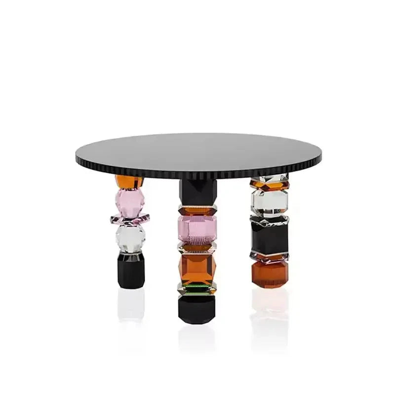 A circular Luxury Glass Coffee Table featuring a dark top and three vibrant, geometric legs, complete with the "BESTing Furniture" logo in the top left corner.