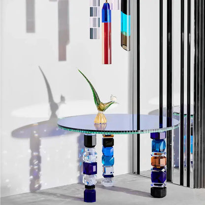 Luxury Glass Coffee Table featuring multicolored geometric legs and a glass bird sculpture, complemented by vertical glass panels.