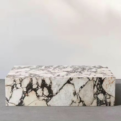 A Calcutta Viola Marble Coffee Table featuring a rectangular white base with black veining.