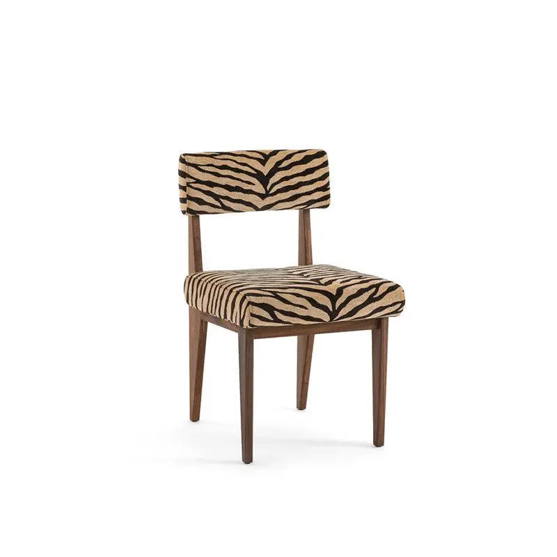 The Savannah Stripes Dining Chair features a wooden frame with a cushioned seat and backrest, both upholstered in a tiger-striped fabric design.