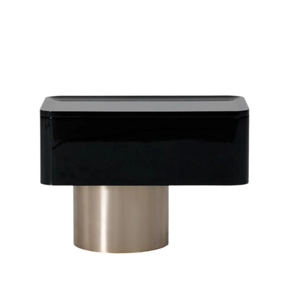 Black and gold cylindrical object on a gray background